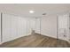 Bedroom features a large closet, wood-look floors, and an ensuite bathroom at 8319 N 14Th St, Tampa, FL 33604