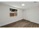 Bedroom featuring new wood-look floors, closet, and a bright window at 8319 N 14Th St, Tampa, FL 33604