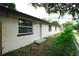 Exterior of the house shows windows, doors and partial vegetation in a low angle view at 8319 N 14Th St, Tampa, FL 33604