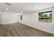 Bright living room with hardwood-style floors and large windows at 8319 N 14Th St, Tampa, FL 33604