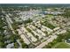 Aerial view showcasing a peaceful neighborhood with tree-lined streets and convenient access to local amenities at 858 Cambridge Ct # 858, Dunedin, FL 34698