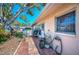 Spacious outdoor patio features brick pavers, mature trees, and a comfortable seating area at 858 Cambridge Ct # 858, Dunedin, FL 34698