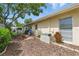 Backyard patio with outdoor grill, privacy fence, landscaping, and shady tree for a relaxing outdoor space at 858 Cambridge Ct # 858, Dunedin, FL 34698