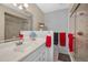 This bathroom has a bright vanity with a mirror and lighting, plus a glass-enclosed shower at 858 Cambridge Ct # 858, Dunedin, FL 34698