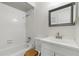 Functional bathroom with a bathtub, shower, and wood-accented vanity at 858 Cambridge Ct # 858, Dunedin, FL 34698