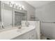 Clean bathroom features a sink, an expansive mirror, modern lighting, and great natural light at 858 Cambridge Ct # 858, Dunedin, FL 34698