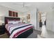 Comfortable bedroom with a bed, ceiling fan, neutral walls, and easy access to ensuite bathroom at 858 Cambridge Ct # 858, Dunedin, FL 34698