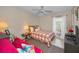 Bright bedroom featuring a ceiling fan and a comfortable bed; the futon offers additional seating at 858 Cambridge Ct # 858, Dunedin, FL 34698