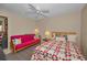 Comfortable bedroom featuring a ceiling fan, a futon for seating, and bright natural light at 858 Cambridge Ct # 858, Dunedin, FL 34698