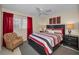 Well-lit bedroom featuring a ceiling fan, large window, and stylish decor with a queen sized bed at 858 Cambridge Ct # 858, Dunedin, FL 34698