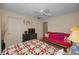 A cozy bedroom with a ceiling fan, a brightly-colored futon, and ample natural light at 858 Cambridge Ct # 858, Dunedin, FL 34698