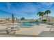 Inviting community pool area with tables, chairs, and umbrellas, perfect for relaxation at 858 Cambridge Ct # 858, Dunedin, FL 34698