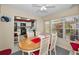 Eat-in dining area features a wooden table, seating for four, and bright natural light from the adjacent window at 858 Cambridge Ct # 858, Dunedin, FL 34698