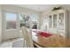 Bright dining room showcasing a classic table, white chairs, and natural light filtering through the windows at 858 Cambridge Ct # 858, Dunedin, FL 34698