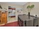 Dining area with modern table setting, plants, and open access to kitchen at 858 Cambridge Ct # 858, Dunedin, FL 34698