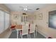 Dining room featuring elegant chairs, a ceiling fan, and sliding door at 858 Cambridge Ct # 858, Dunedin, FL 34698