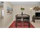 Dining room with modern table setting, plants, and bright lights at 858 Cambridge Ct # 858, Dunedin, FL 34698