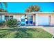 Home with lawn, front porch, and attached garage for a cozy and convenient living space at 858 Cambridge Ct # 858, Dunedin, FL 34698