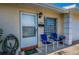 Welcoming home with a well-kept lawn, hose, and a cozy front porch seating area at 858 Cambridge Ct # 858, Dunedin, FL 34698