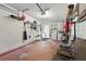 Organized garage with storage racks, hanging tools, laundry, and seating area for convenience and functionality at 858 Cambridge Ct # 858, Dunedin, FL 34698