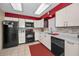 Updated kitchen featuring modern appliances, ample counter space, and stylish backsplash at 858 Cambridge Ct # 858, Dunedin, FL 34698
