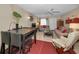 Open-concept living room featuring tiled floors, comfortable seating, and a view to the entry at 858 Cambridge Ct # 858, Dunedin, FL 34698