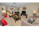 Comfortable living room with tile floors, bright lighting, and view to the dining area at 858 Cambridge Ct # 858, Dunedin, FL 34698