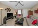 Cozy living room featuring tiled floors, comfortable seating, and bright lights at 858 Cambridge Ct # 858, Dunedin, FL 34698