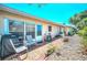 Cozy patio area with chairs, grill, and a garden, providing a relaxing outdoor space at 858 Cambridge Ct # 858, Dunedin, FL 34698