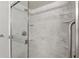 Updated shower featuring marble tiling, glass doors, and sleek fixtures at 858 Cambridge Ct # 858, Dunedin, FL 34698