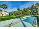 Recreational shuffleboard court surrounded by mature trees, offering outdoor activities at 858 Cambridge Ct # 858, Dunedin, FL 34698