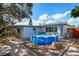 Backyard featuring an above-ground pool, covered patio and paved walkway to the house at 1214 Stover Ct, Holiday, FL 34691