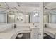 Bright bathroom features a large mirror, vanity, sink and toilet at 1214 Stover Ct, Holiday, FL 34691