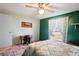 This cozy bedroom has a ceiling fan, a window, and a desk at 1214 Stover Ct, Holiday, FL 34691