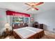 Bright bedroom with large windows, wood accents, and comfortable furnishings at 1214 Stover Ct, Holiday, FL 34691