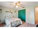 This bedroom features a ceiling fan, a closet, and an olive-colored accent wall at 1214 Stover Ct, Holiday, FL 34691