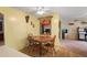 Cozy dining area features a round table with four chairs and rustic decor, creating a warm atmosphere at 1214 Stover Ct, Holiday, FL 34691