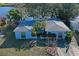 Waterfront home featuring a cozy front yard and lush landscaping at 1214 Stover Ct, Holiday, FL 34691