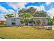 Charming home with a spacious front yard and mature trees at 1214 Stover Ct, Holiday, FL 34691