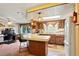 Kitchen with a breakfast bar, warm wood cabinetry, and white appliances at 1214 Stover Ct, Holiday, FL 34691