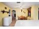 Kitchen and dining area featuring wood cabinets, a ceiling fan, and vintage decor at 1214 Stover Ct, Holiday, FL 34691