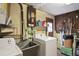 Utility room equipped with a washer, dryer, laundry sink, and shelving for storage at 1214 Stover Ct, Holiday, FL 34691