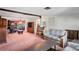Comfortable living room with a vintage sofa, rocking chair, and decorative wood accents at 1214 Stover Ct, Holiday, FL 34691