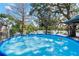 Relax by the pool with a lake view at this serene backyard getaway at 1214 Stover Ct, Holiday, FL 34691
