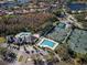 Beautiful aerial view of community amenities including pool, clubhouse, and tennis courts at 10218 Garden Alcove Dr, Tampa, FL 33647