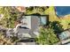 Aerial view of a house with a screened pool and close proximity to a lake at 10218 Garden Alcove Dr, Tampa, FL 33647