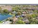 Aerial view of a home with a screened pool and a stunning lake view at 10218 Garden Alcove Dr, Tampa, FL 33647