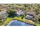Aerial view highlighting a screened-in pool and private backyard, bordering a serene lake, surrounded by mature trees at 10218 Garden Alcove Dr, Tampa, FL 33647