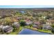 Aerial view of a home with a screened pool and a beautiful lake view at 10218 Garden Alcove Dr, Tampa, FL 33647