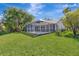 Expansive, well-maintained backyard with a screened-in pool area, perfect for outdoor relaxation and entertainment at 10218 Garden Alcove Dr, Tampa, FL 33647